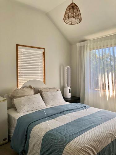 a bedroom with a large bed with a window at Homestay near CHC Airport - 2 rooms in Christchurch