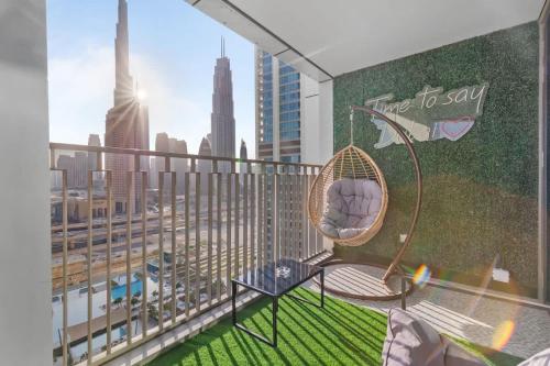 a balcony with a hammock and a view of a city at New Stunning 4 BR Burj Khalifa View in Dubai