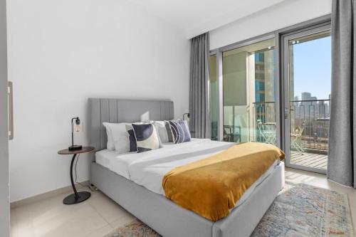 a bedroom with a large bed and a large window at New Stunning 4 BR Burj Khalifa View in Dubai