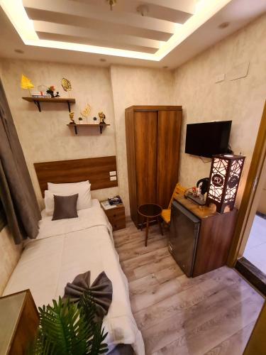 a hotel room with a bed and a television at tourist hotel cairo downtown in Cairo