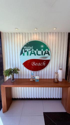 a sign for a hotel tamale beach on a wall at Hotel Italia Beach - Na Beira Mar Natal RN in Natal