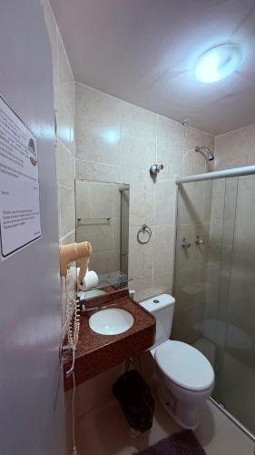 a bathroom with a toilet and a sink and a shower at Hotel Italia Beach - Na Beira Mar Natal RN in Natal
