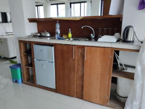 a kitchen counter with a sink and a dishwasher at Résidence 5ème Ciel in Douala