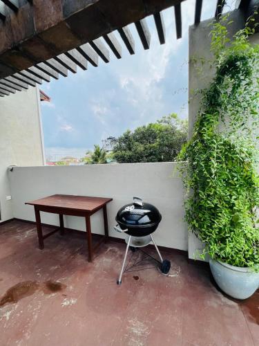 a table and a chair sitting on a patio at Uyana View in Moratuwa
