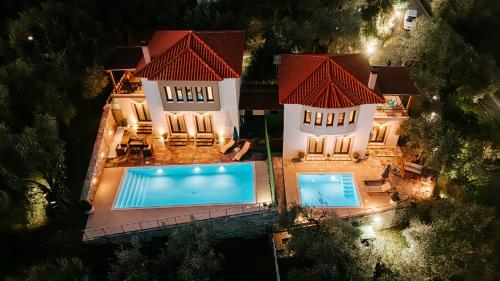 an aerial view of a house with two swimming pools at PELIONBLUE VILLAs in Volos