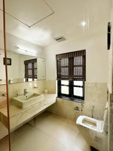 a bathroom with a sink and a mirror at Silver Sands Hideaway Resort, Candolim in Candolim