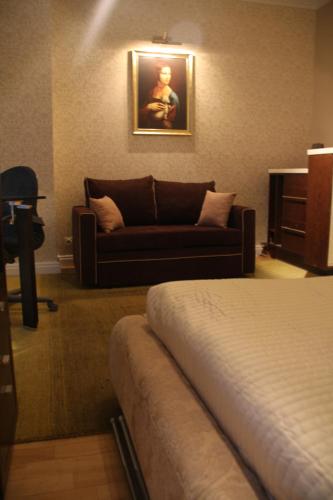 a living room with a couch and a bed at President Apartments by WarsawResidence Group in Warsaw