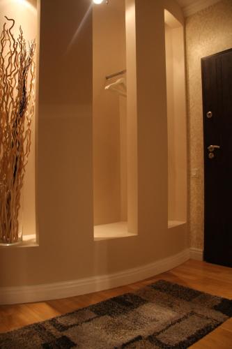 a bathroom with a mirror and a vase on the wall at President Apartments by WarsawResidence Group in Warsaw