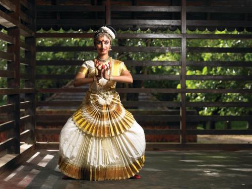 a woman in a gold and white dress at Namasthe Ayurveda and Yoga Retreat Cochin in Nedumbassery