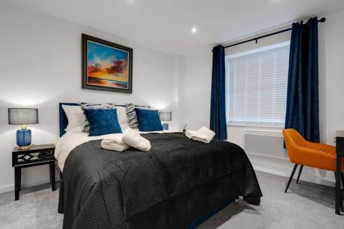 a bedroom with a bed with blue curtains and a window at Brighton Apt - 2 Bedroom Free Wi-Fi & Parking in Wallasey
