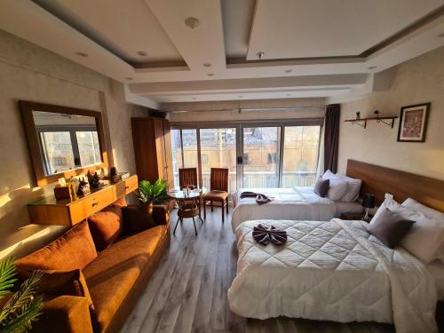 a hotel room with two beds and a couch at tourist hotel cairo downtown in Cairo