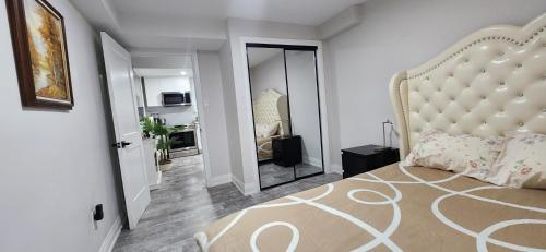 a bedroom with a large bed with a large headboard at Entire 2 Bedroom Apartment in Kitchener in Kitchener