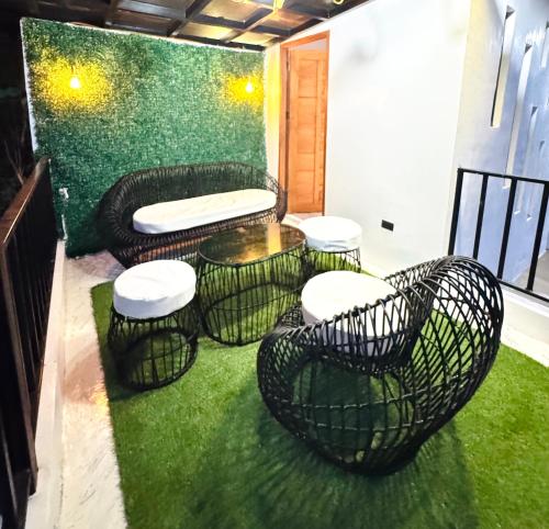 a balcony with a table and chairs on the grass at Oceanview Exclusive Home Villanueva Jasaan in Jasaan