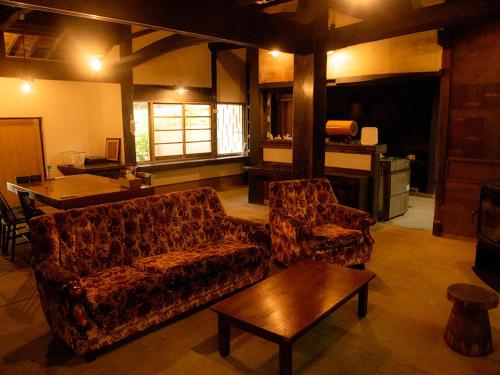 a living room with two couches and a table at GOYADO in Ozu