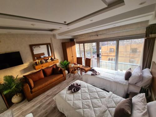 a large living room with two beds and a couch at tourist hotel cairo downtown in Cairo