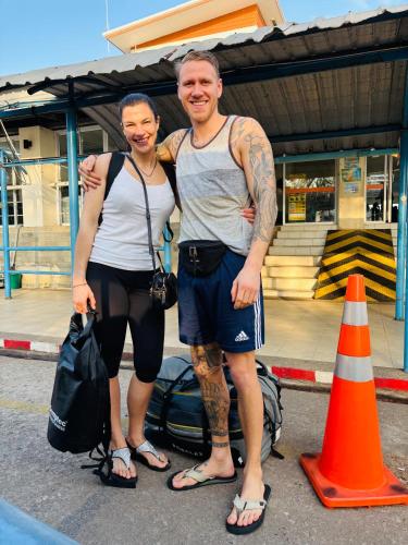 a man and a woman standing next to an orange cone at Baansrisuthum in Don Sak