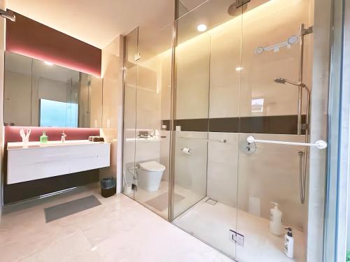 a bathroom with a glass shower and a toilet at Tropicana The Residence KLCC in Kuala Lumpur