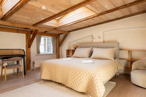 a bedroom with a bed and a chair and a table at Charming 4BR Duplex in Nørrebro in Copenhagen