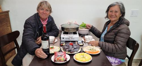 two older women sitting at a table with food at ToTo-Chan Hotel in Dồng Văn