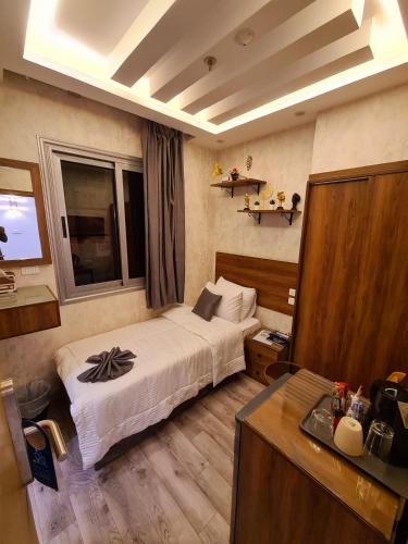 a hotel room with a bed and a television at tourist hotel cairo downtown in Cairo