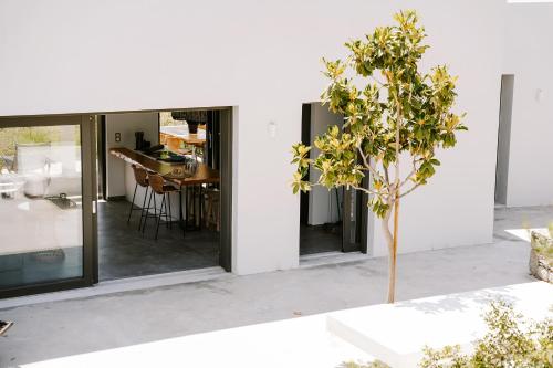a small tree in front of a house at Hidden Hill Naxos Villas in Kastraki Naxou