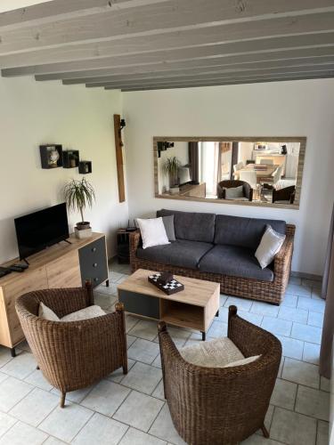 a living room with a couch and a table at LE TEMPS D'UN INSTANT in Vattetot-sur-Mer