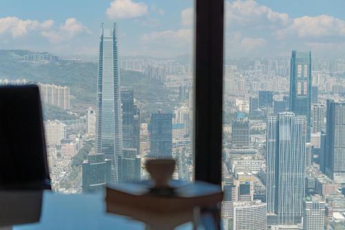 a view of a city skyline from a window at The St. Regis Shenzhen in Shenzhen