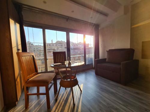 a living room with a table and a couch and a window at tourist hotel cairo downtown in Cairo