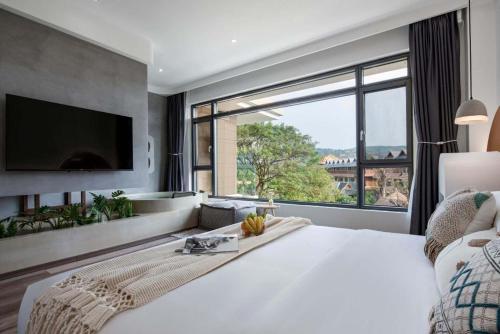 Xishuangbanna Verdant House Resort Hotelにあるベッド