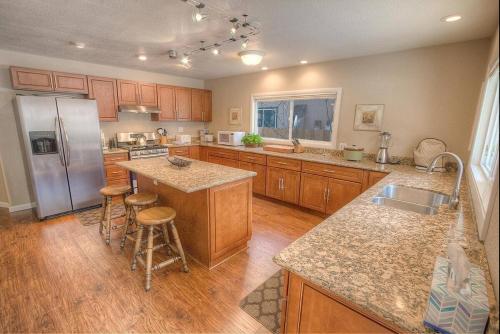 a kitchen with wooden cabinets and a stainless steel refrigerator at Corner Pocket Chalet home in South Lake Tahoe
