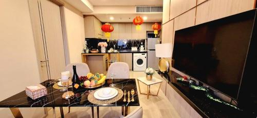 a kitchen with a table and chairs in a room at Panora 2-Bedroom Apartment with Sea View in Pattaya South