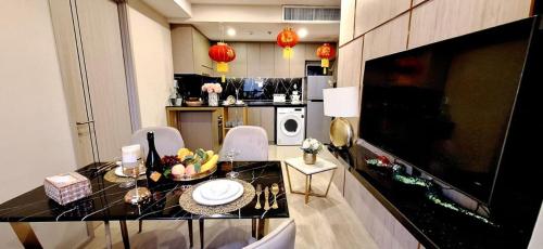 a kitchen with a table and chairs in a room at Panora 2-Bedroom Apartment with Sea View in Pattaya South