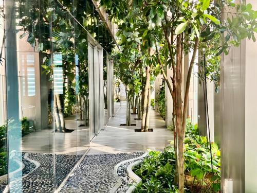 a corridor with trees and plants in a building at Tropicana The Residence KLCC in Kuala Lumpur