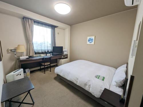 Postel nebo postele na pokoji v ubytování Hotel Route-Inn Court Shinonoi