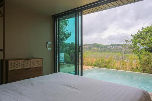 Postel nebo postele na pokoji v ubytování AKRA Collection Layan - Hideaway Villas
