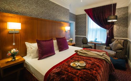 a hotel room with a bed with two plates on it at Sligo Southern Hotel & Leisure Centre in Sligo