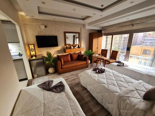 a bedroom with two beds and a living room at tourist hotel cairo downtown in Cairo