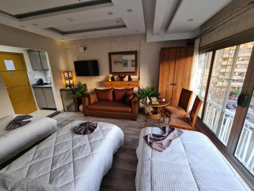 a hotel room with two beds and a couch at tourist hotel cairo downtown in Cairo