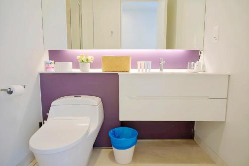 a bathroom with a white toilet and a sink at Tropicana The Residence KLCC in Kuala Lumpur