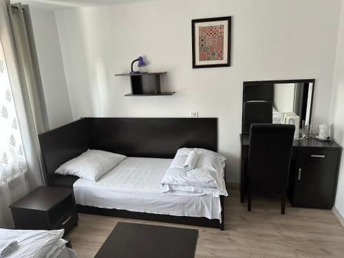 a small bedroom with a bed and a desk at DUKAT in Horyniec Zdrój