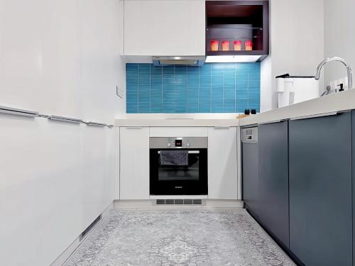 a kitchen with white cabinets and an oven at Tropicana The Residence KLCC in Kuala Lumpur