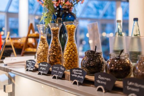 a display of vases and jars of food on a shelf at Globana Airport Hotel in Schkeuditz
