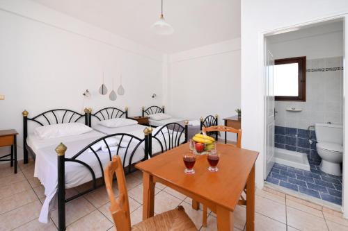 a bedroom with a bed and a table with drinks on it at Maridim studios in Ermoupoli