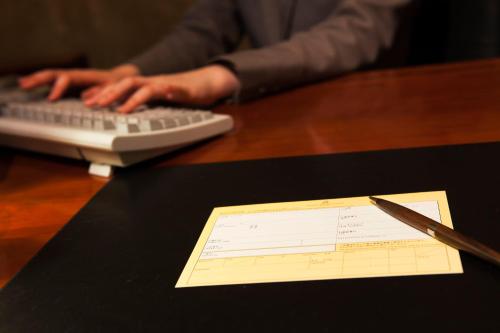 a desk with a computer keyboard and a paper at Urayasu Brighton Hotel Tokyo Bay in Urayasu