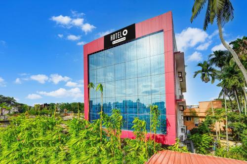a building with a sign on the side of it at Super Hotel O Attukal Near Attakulangara formerly Remya Residency in Trivandrum