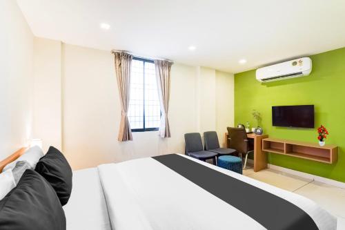 a hotel room with a bed and a tv at Super Townhouse Krishnagiri formerly Vijay Inn in Krishnagiri
