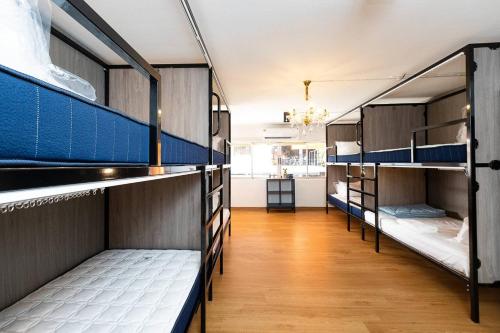 a group of bunk beds in a room at Orange Lodge in Bangkok