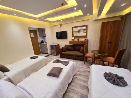 a hotel room with two beds and a living room at tourist hotel cairo downtown in Cairo