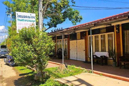a building with a sign on the side of it at Thai Gallery Baantawai in Chiang Mai