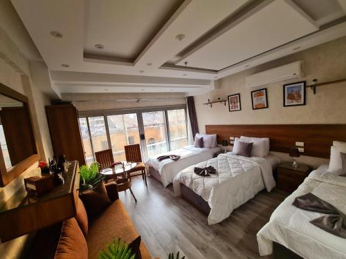 a hotel room with two beds and a couch at tourist hotel cairo downtown in Cairo